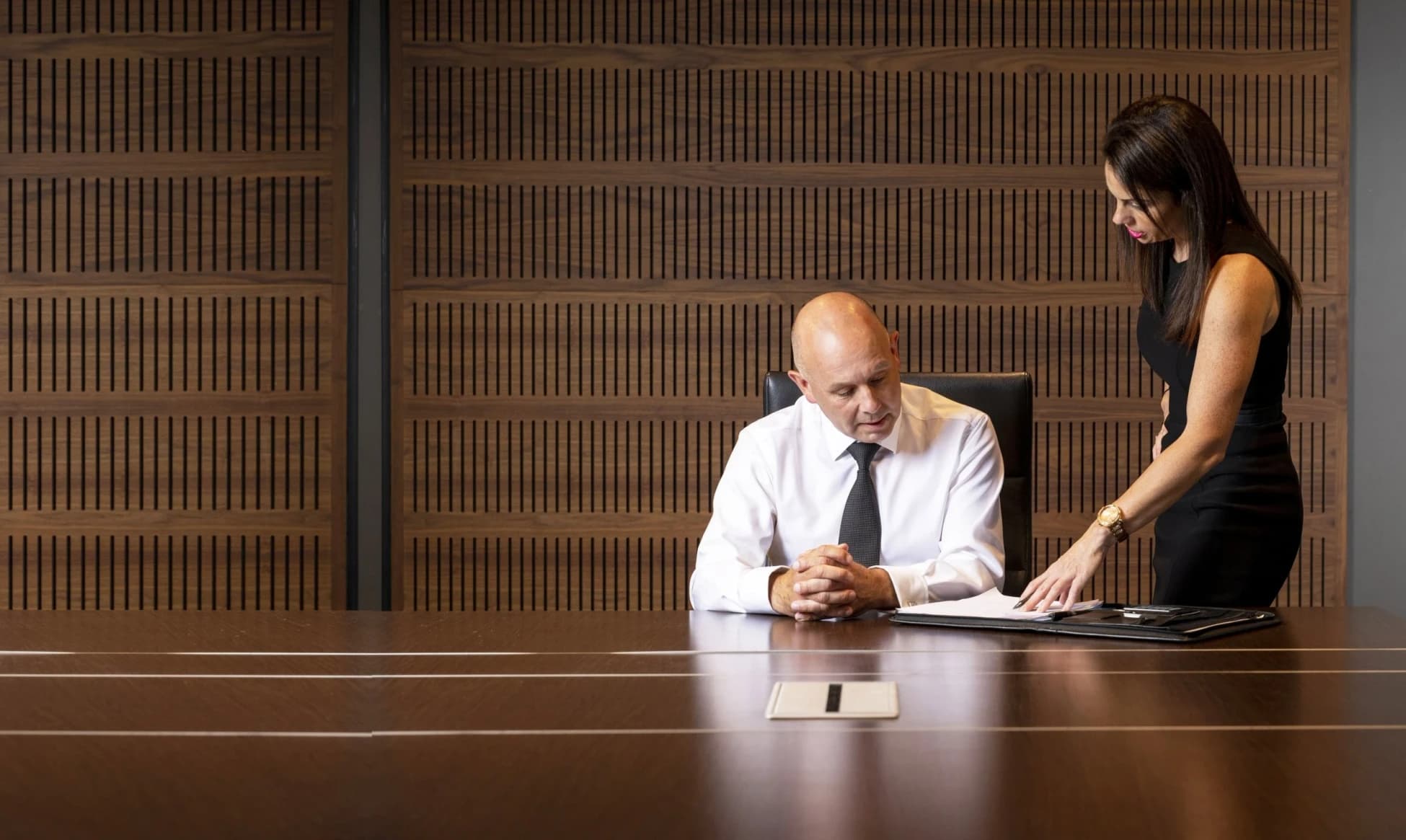 Bernard Whimp and Tracy MacDonald viewing documentation on a desk.