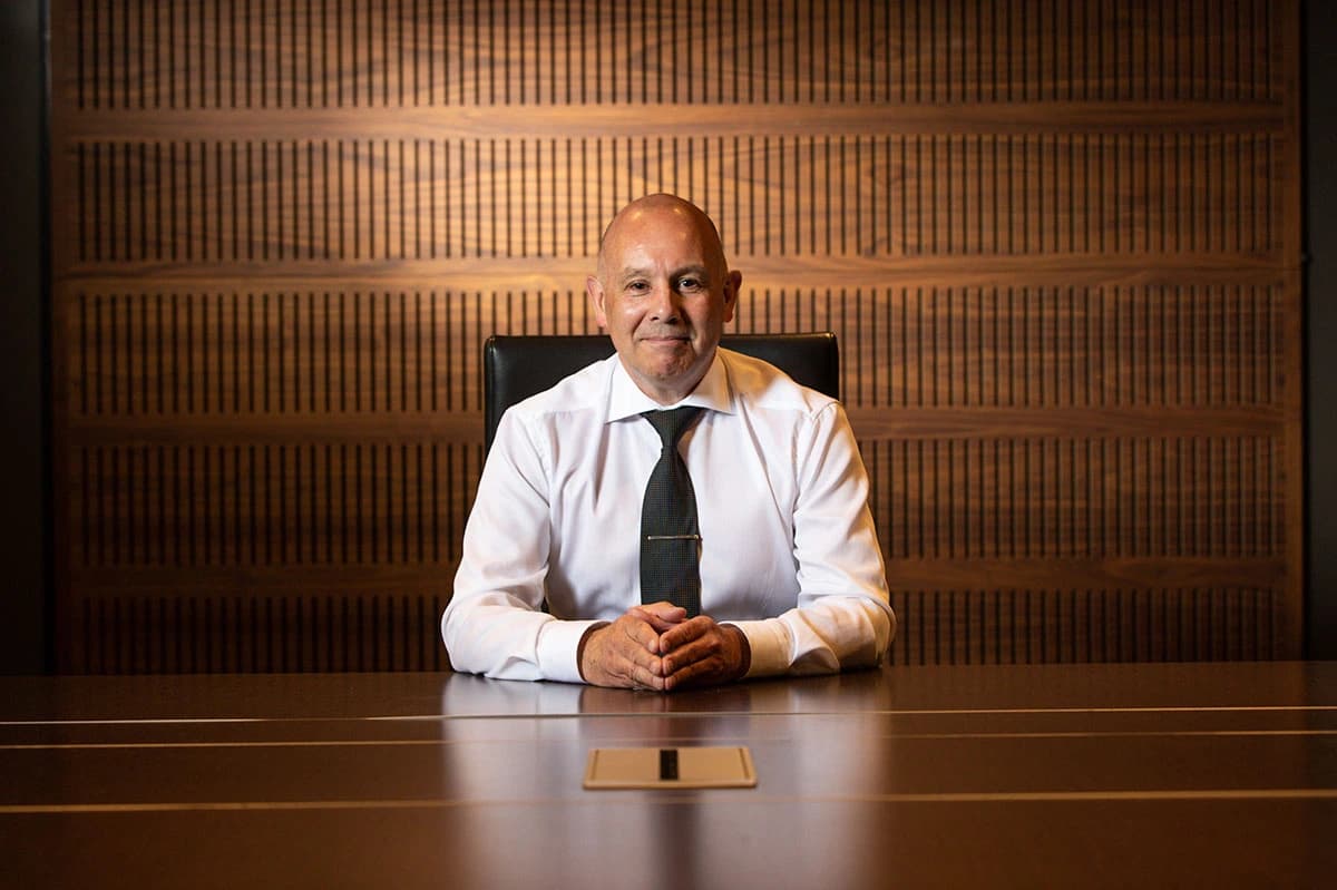 Bernard Whimp, Chance Voight Founder, CEO/CIO sitting at a desk