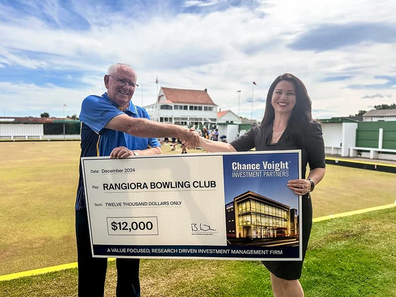 Chance Voight Business Development Manager shakes hands with Rangiora Bowling Club Member receiving large cheque for $12,000 dollars