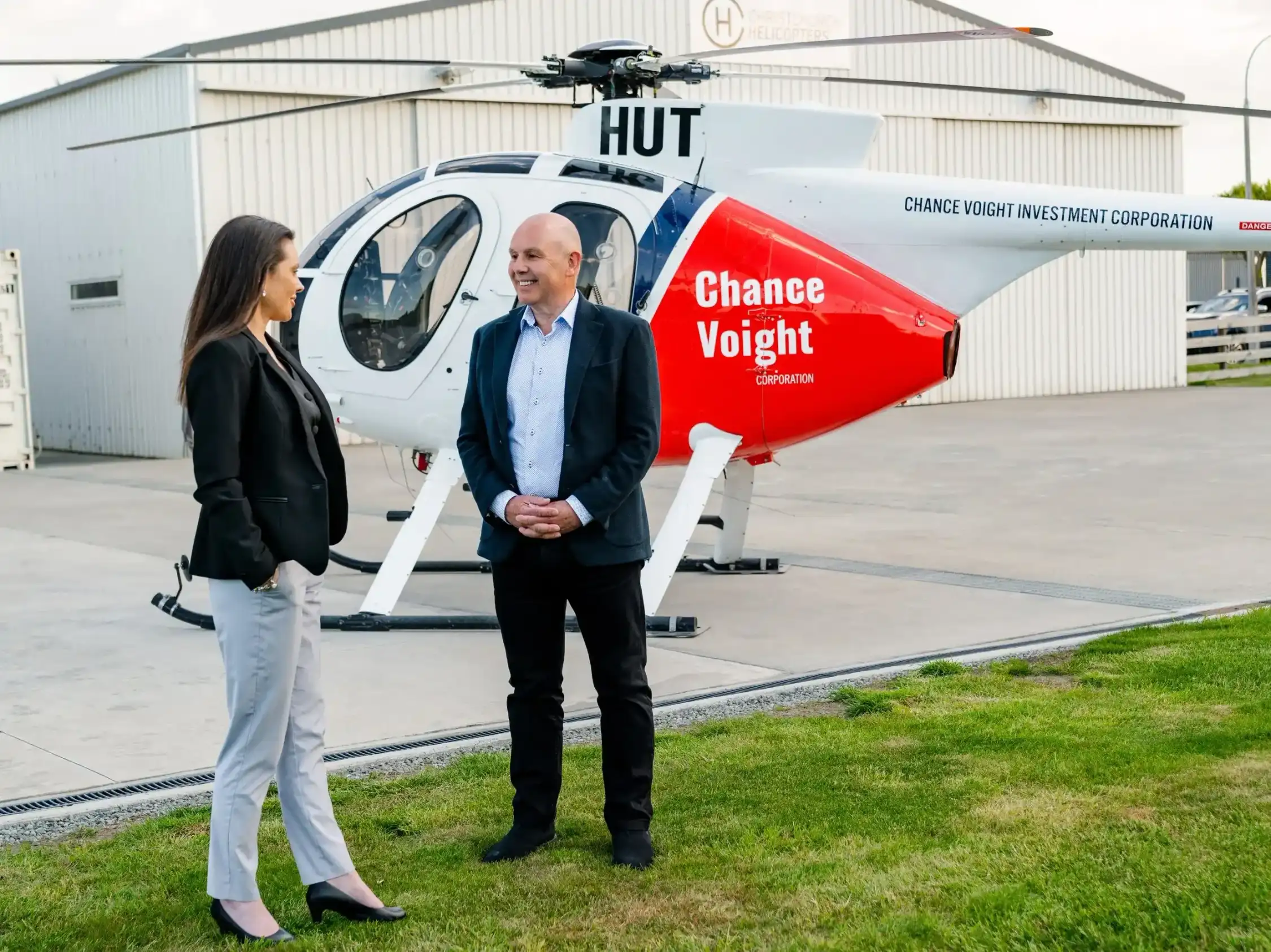 Bernard Whimp and Tracy MacDonald standing in front of Chance Voight Helicopter.